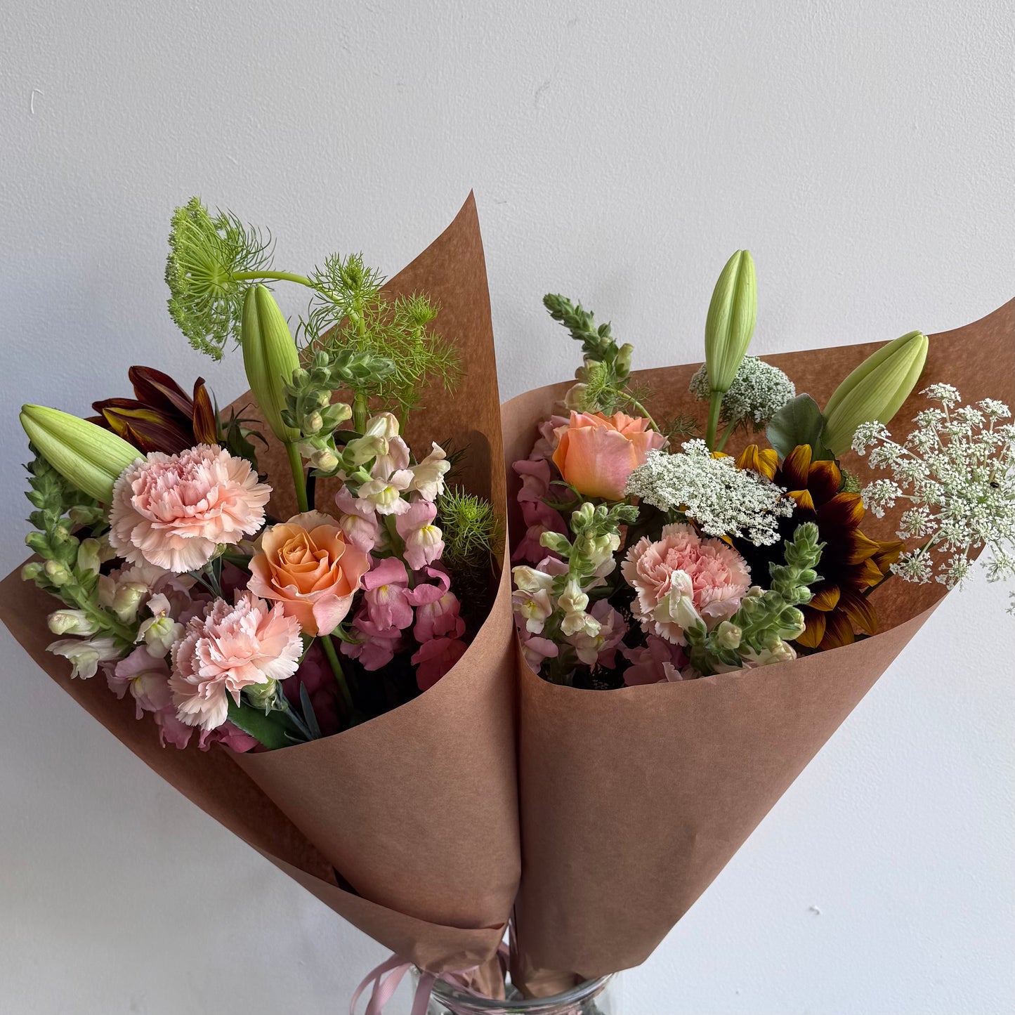 Soft pretty flowers in pinks and white wrapped in Kraft paper. Designed by Bendigo Florist Blumetown.