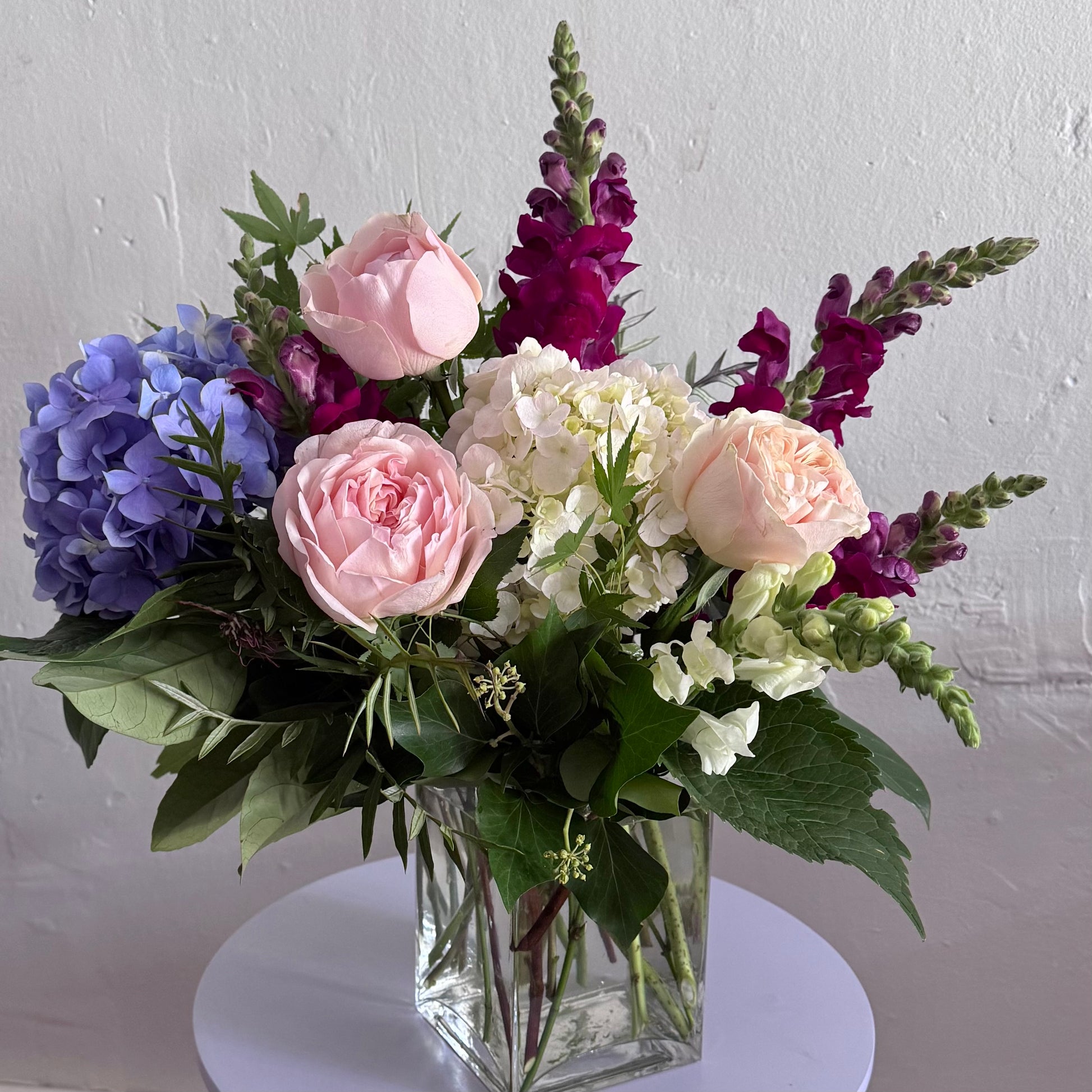 Abundant of fresh seasonal flowers designed in a glass vase. Delivered by Bendigo Florist Blumetown. 