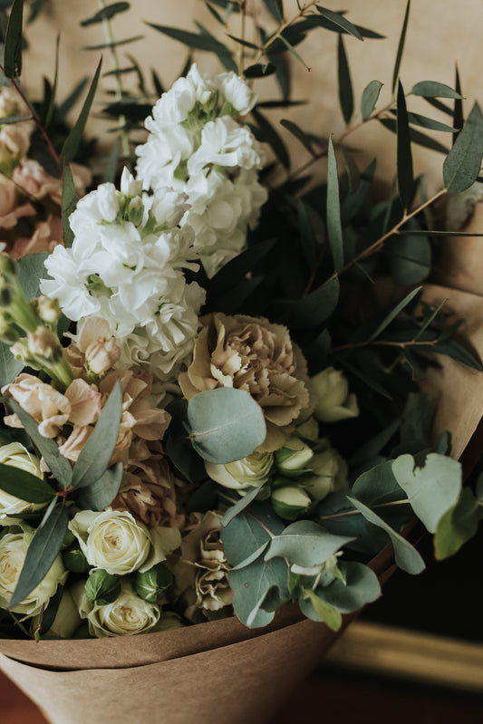 Soft pastel seasonal flowers in Bendigo wrapped in white paper and tissue. Compostable wrap and paper. Bendigo Florist.