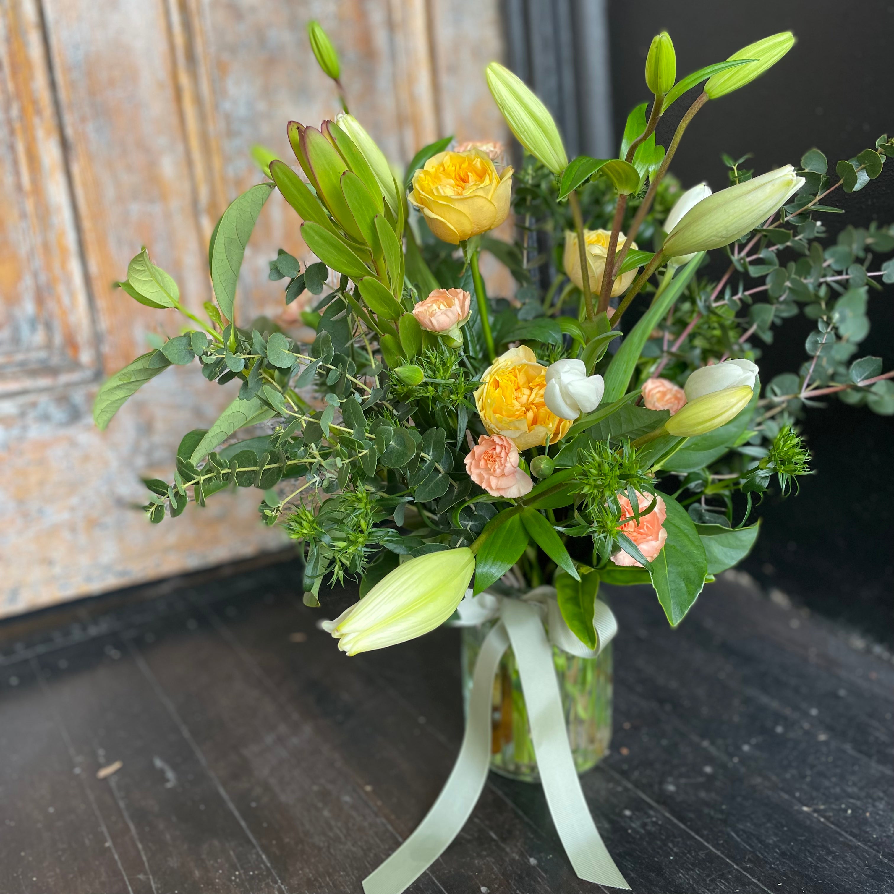 Bendigo Florist Blumetown Yellow, Peach and White flowers in glass vase with sage green ribbon. 