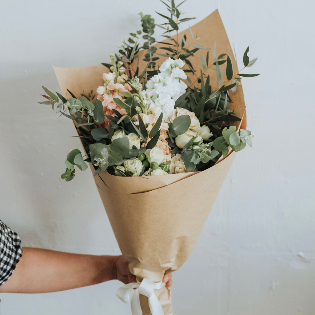 Soft pastel seasonal flowers in Bendigo wrapped in white paper and tissue. Compostable wrap and paper.  