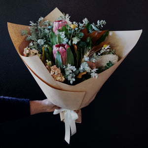Native and Pastel flower mix with lush foliage Bendigo. Bouquet wrapped in brown paper with cream ribbon or offered in a vase. Billy buttons featured in arrangement. 